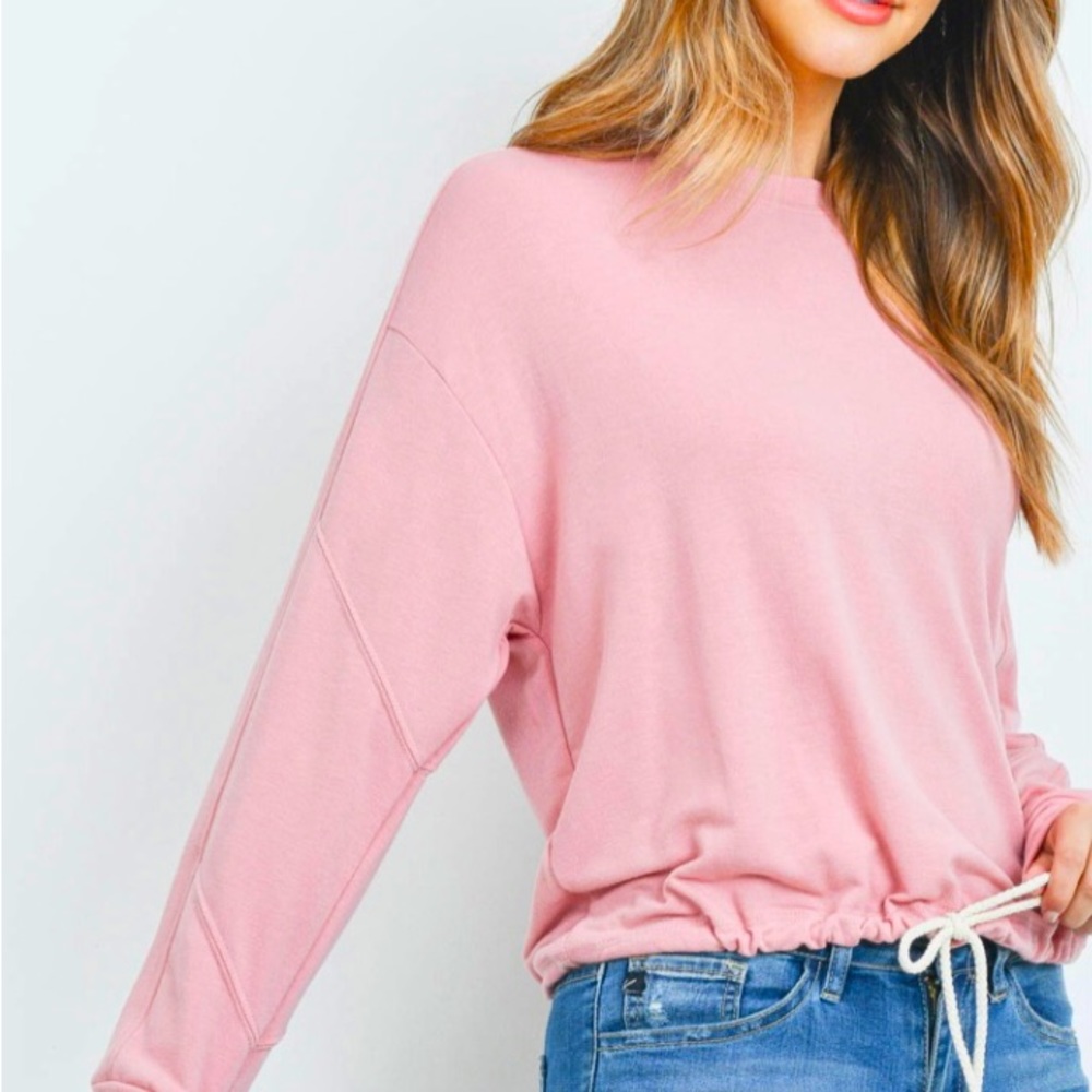 Long sleeve pullover sweatshirt with drawstring hem